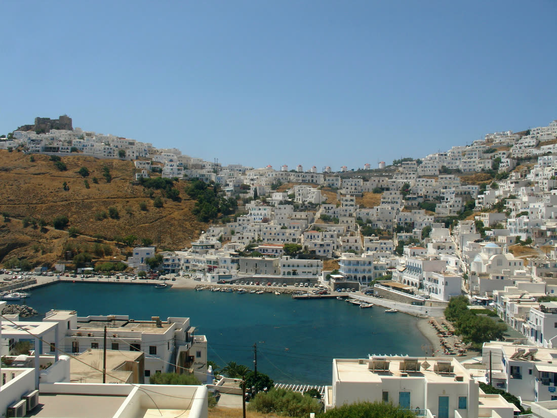 Whitewashed houses above the blue Aegean sea